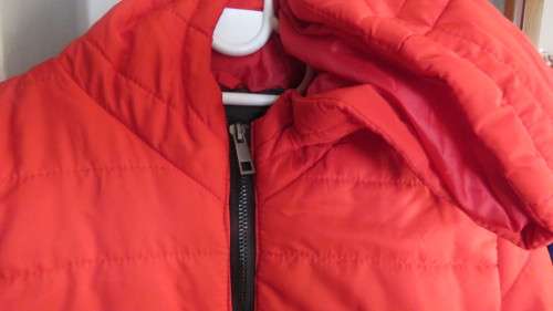As new red padded long sleeve hooded jacket size 30/6 by RT. Kangaroo pockets.100% polyester.