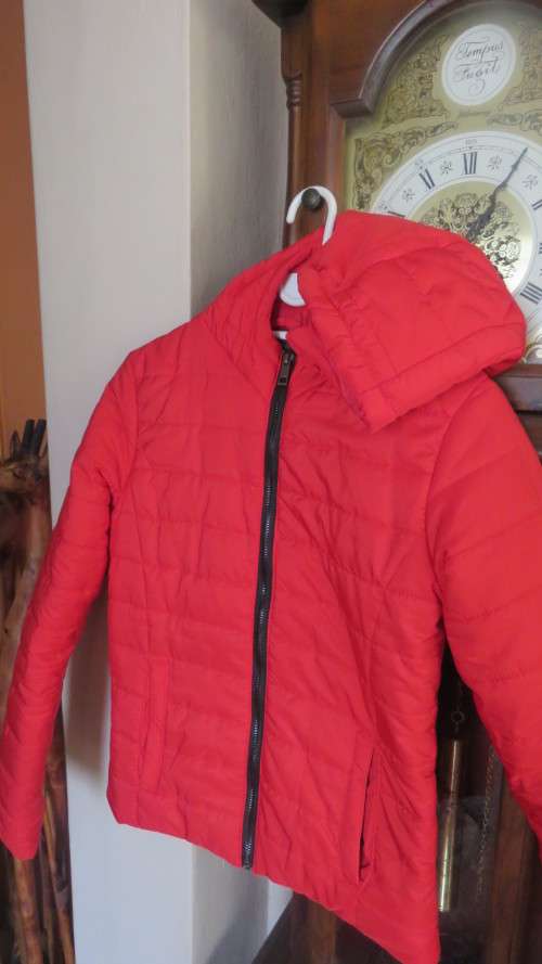 As new red padded long sleeve hooded jacket size 30/6 by RT. Kangaroo pockets.100% polyester.