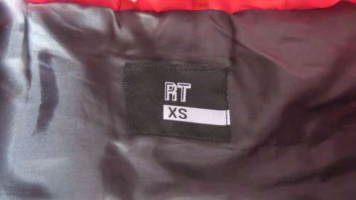 As new red padded long sleeve hooded jacket size 30/6 by RT. Kangaroo pockets.100% polyester.