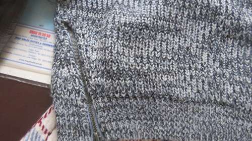 Soft cosy acrylic knit long sleeve jumper in black/white mottled look.Two short zips.Size 34  As new