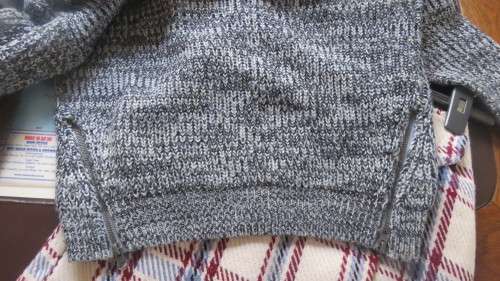 Soft cosy acrylic knit long sleeve jumper in black/white mottled look.Two short zips.Size 34  As new