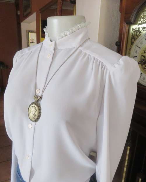 Stylish 80`s long sleeve button down light grey blouse with high banded collar.Size 32 by FOSHINI.