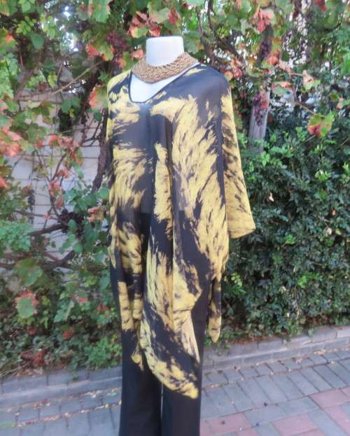Stunning throw over top in black and mustard sheer polyester. Neckline edged with black satin.As new