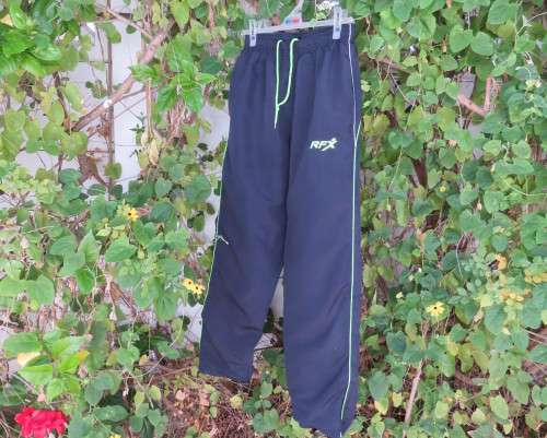Men`s navy polyester tracksuit pants with green edging size Medium by REFLEX.Zips on leg seams.