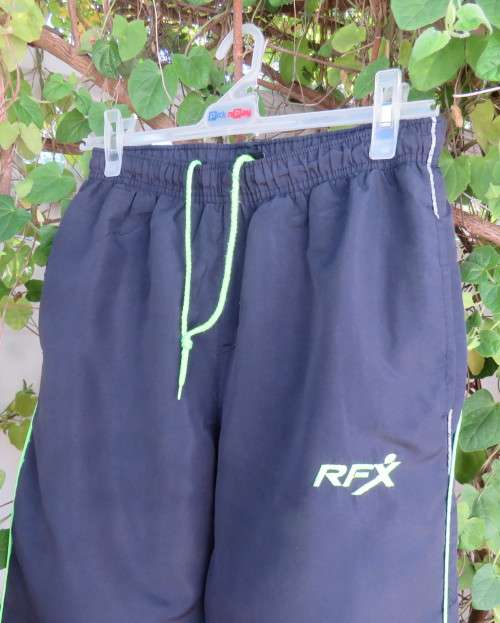 Men`s navy polyester tracksuit pants with green edging size Medium by REFLEX.Zips on leg seams.