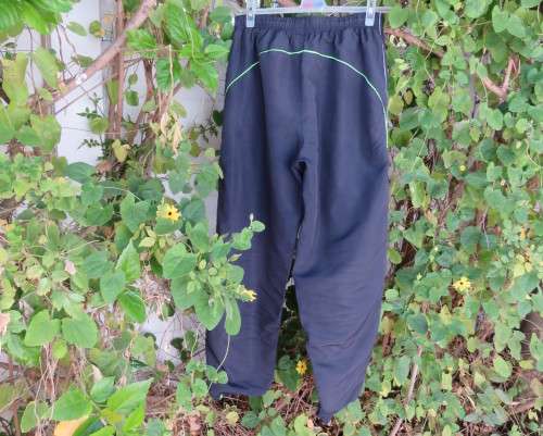 Men`s navy polyester tracksuit pants with green edging size Medium by REFLEX.Zips on leg seams.