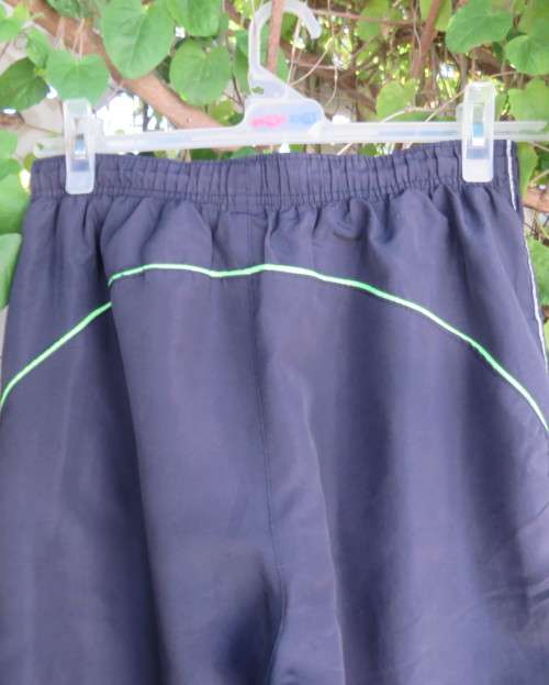 Men`s navy polyester tracksuit pants with green edging size Medium by REFLEX.Zips on leg seams.