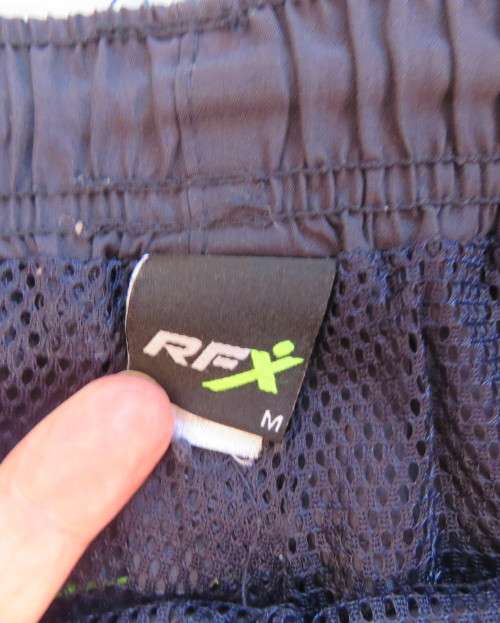 Men`s navy polyester tracksuit pants with green edging size Medium by REFLEX.Zips on leg seams.