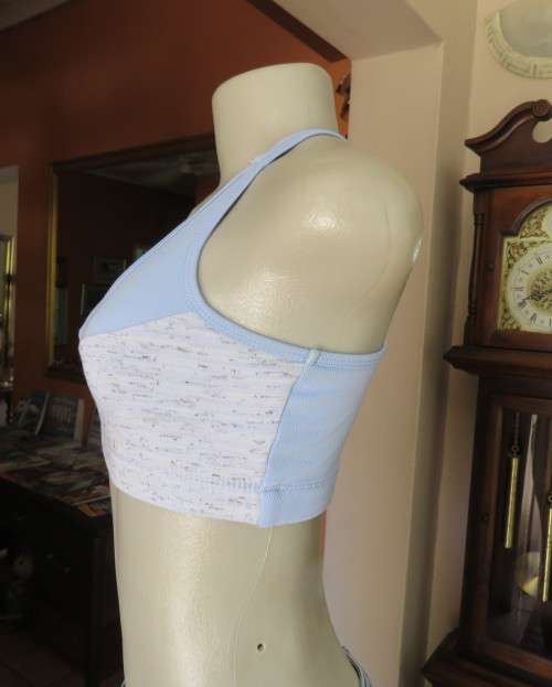 As new light blue size 32 sports bra by MAXED in stretch polyester.
