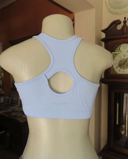 As new light blue size 32 sports bra by MAXED in stretch polyester.