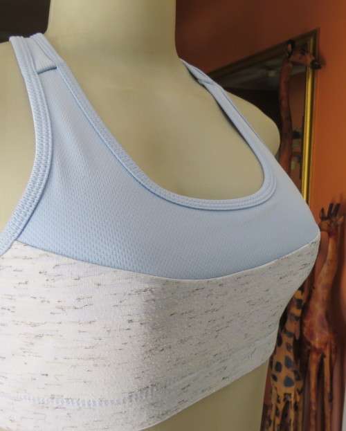 As new light blue size 32 sports bra by MAXED in stretch polyester.