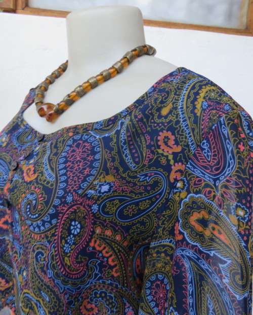 Marvelous sheer polyester lined slip over dress in blues,peach and gold paisley pattern.Size 38/14