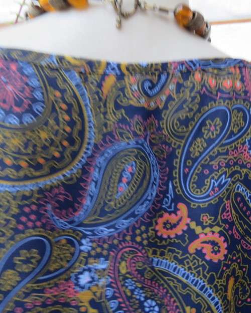 Marvelous sheer polyester lined slip over dress in blues,peach and gold paisley pattern.Size 38/14