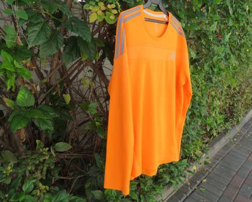Striking original ADIDAS running slip over long sleeve top in orange polyester size XL.As new