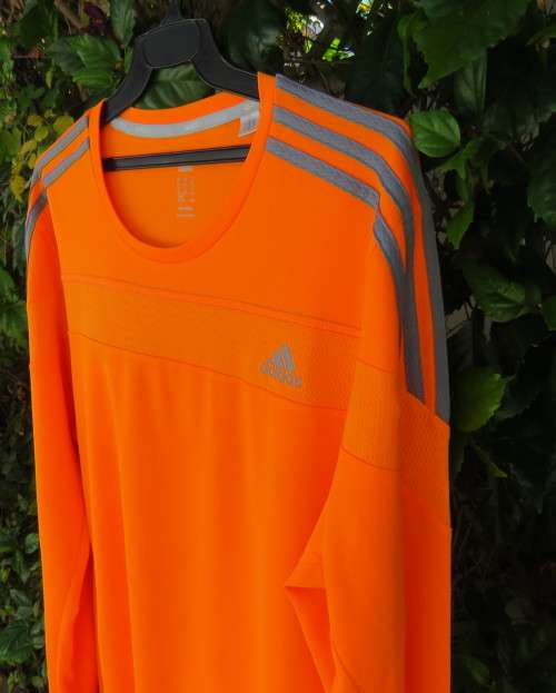 Striking original ADIDAS running slip over long sleeve top in orange polyester size XL.As new