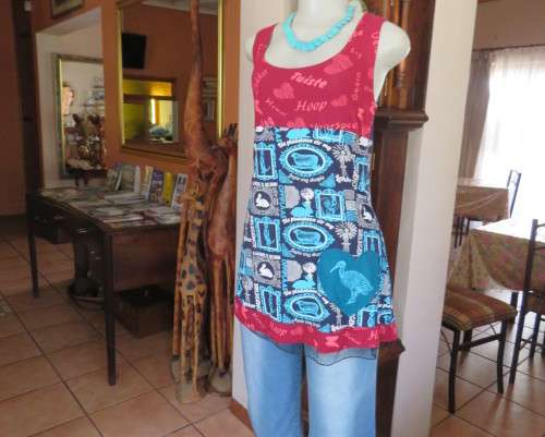Delightful long navy top with maroon bust area. With Afrikaans logos and pictures.Size 34.As new