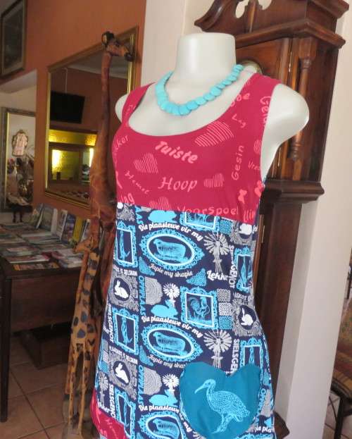 Delightful long navy top with maroon bust area. With Afrikaans logos and pictures.Size 34.As new