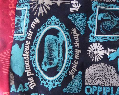 Delightful long navy top with maroon bust area. With Afrikaans logos and pictures.Size 34.As new