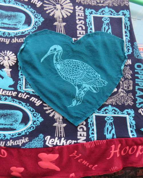 Delightful long navy top with maroon bust area. With Afrikaans logos and pictures.Size 34.As new