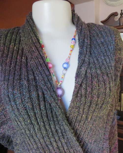 Warm acrylic knit dark jewel colour long sleeve cardigan.Double breast. Size 42 to 44.Very good cond