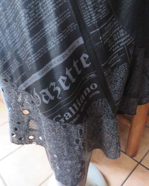 Sexy,shiny black long top with scooped neckline.Size 38/14.Circle panels in lace and poly.As new