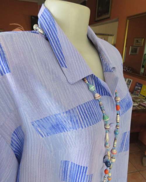 Smart light blue with darker blue graphic designs.Button down with open collar.Owner made size 44/20