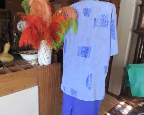 Smart light blue with darker blue graphic designs.Button down with open collar.Owner made size 44/20