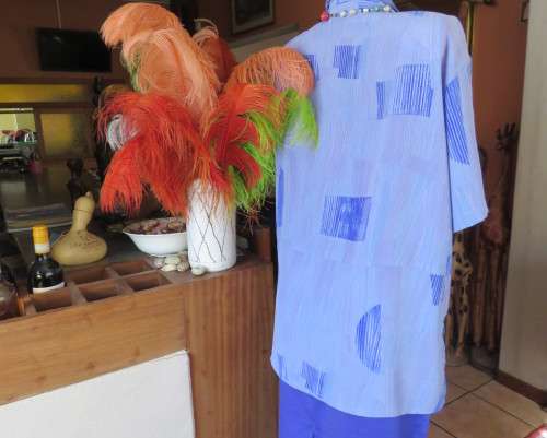 Smart light blue with darker blue graphic designs.Button down with open collar.Owner made size 44/20