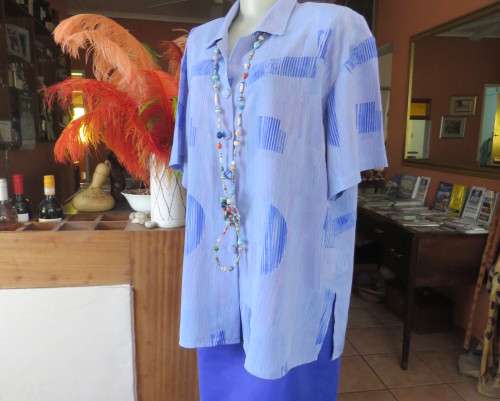 Smart light blue with darker blue graphic designs.Button down with open collar.Owner made size 44/20