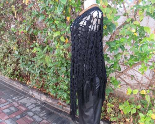 Black crochet lace stitch poncho in double knit acrylic yarn. Fringed. By KELSO.Best fit 32 to 36.