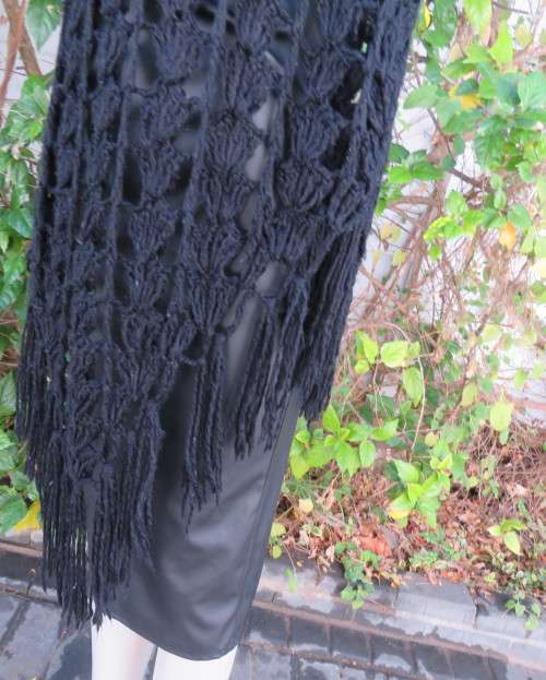 Black crochet lace stitch poncho in double knit acrylic yarn. Fringed. By KELSO.Best fit 32 to 36.