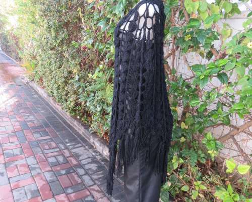 Black crochet lace stitch poncho in double knit acrylic yarn. Fringed. By KELSO.Best fit 32 to 36.