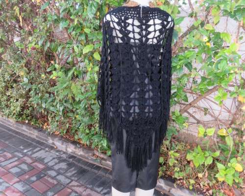 Black crochet lace stitch poncho in double knit acrylic yarn. Fringed. By KELSO.Best fit 32 to 36.