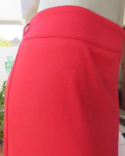 Smart red pencil skirt in red jersey fabric with some stretch.Size 42/18. Pleat at back. As new.