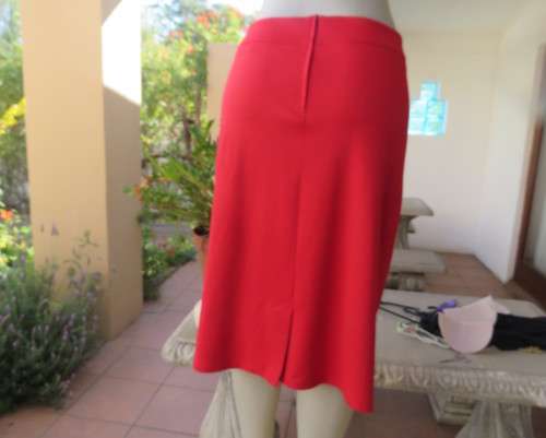 Smart red pencil skirt in red jersey fabric with some stretch.Size 42/18. Pleat at back. As new.