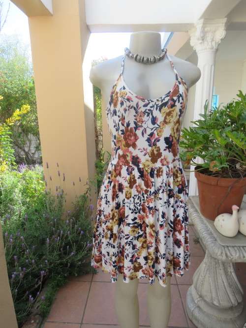 Cute white summer dress with autumn colour flowers. Halter neck with 6 thin straps at back.Size 32/8