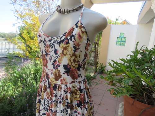 Cute white summer dress with autumn colour flowers. Halter neck with 6 thin straps at back.Size 32/8