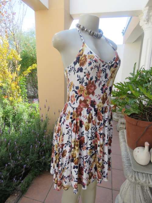 Cute white summer dress with autumn colour flowers. Halter neck with 6 thin straps at back.Size 32/8