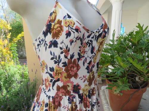 Cute white summer dress with autumn colour flowers. Halter neck with 6 thin straps at back.Size 32/8
