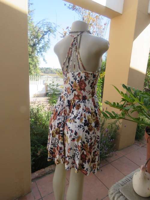 Cute white summer dress with autumn colour flowers. Halter neck with 6 thin straps at back.Size 32/8