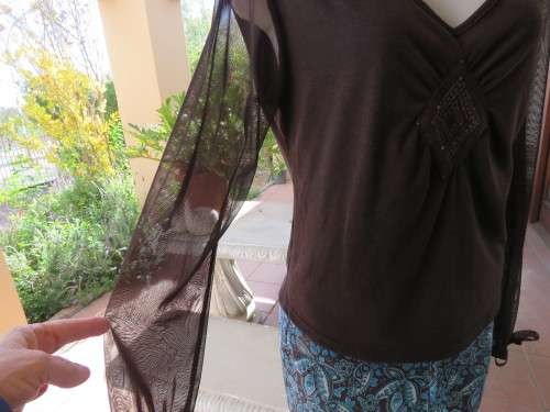 Choc brown stretch viscose slip over top.See through long sleeves.V neck.Diamond shape decor.Size 38
