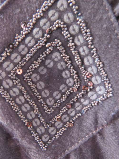 Choc brown stretch viscose slip over top.See through long sleeves.V neck.Diamond shape decor.Size 38