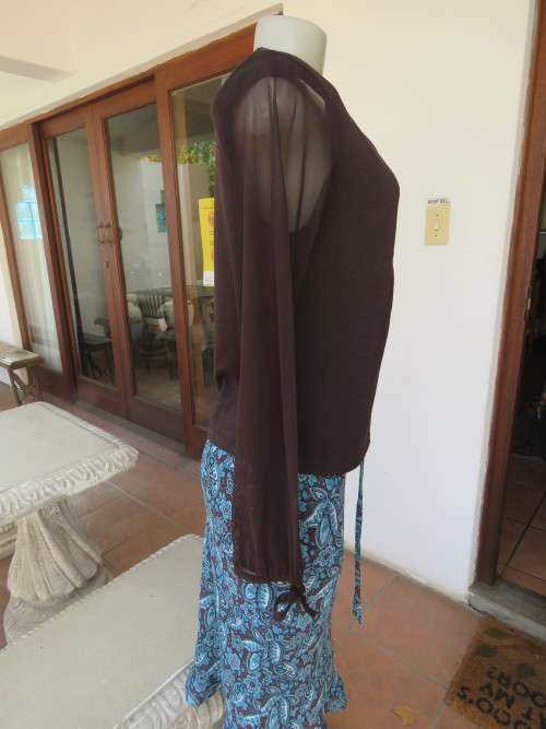 Choc brown stretch viscose slip over top.See through long sleeves.V neck.Diamond shape decor.Size 38