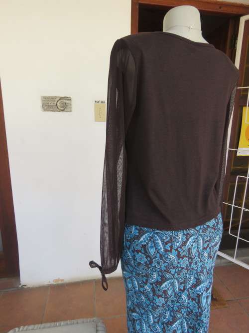 Choc brown stretch viscose slip over top.See through long sleeves.V neck.Diamond shape decor.Size 38