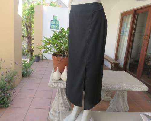 Elegant ankle length black pencil skirt. Slit at left side and button decoration in waist.Size 36