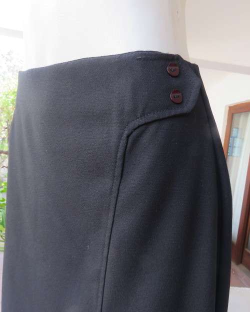 Elegant ankle length black pencil skirt. Slit at left side and button decoration in waist.Size 36