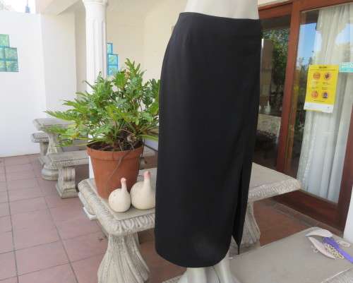 Elegant ankle length black pencil skirt. Slit at left side and button decoration in waist.Size 36