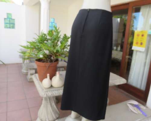 Elegant ankle length black pencil skirt. Slit at left side and button decoration in waist.Size 36