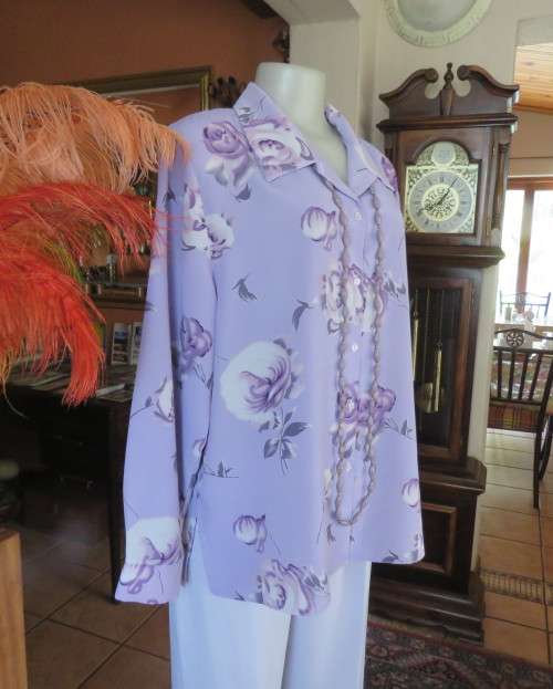 Lavender long sleeve blouse with button down front. Bold purple/white flowers.Size 42 by AREZZO.