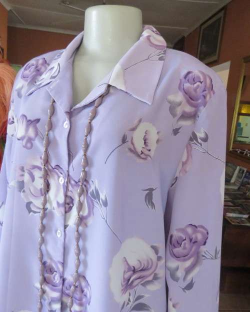 Lavender long sleeve blouse with button down front. Bold purple/white flowers.Size 42 by AREZZO.
